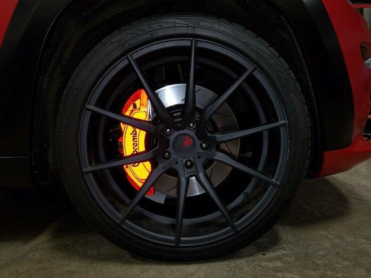 Yellow Brembo brake calliper behind a black alloy wheel