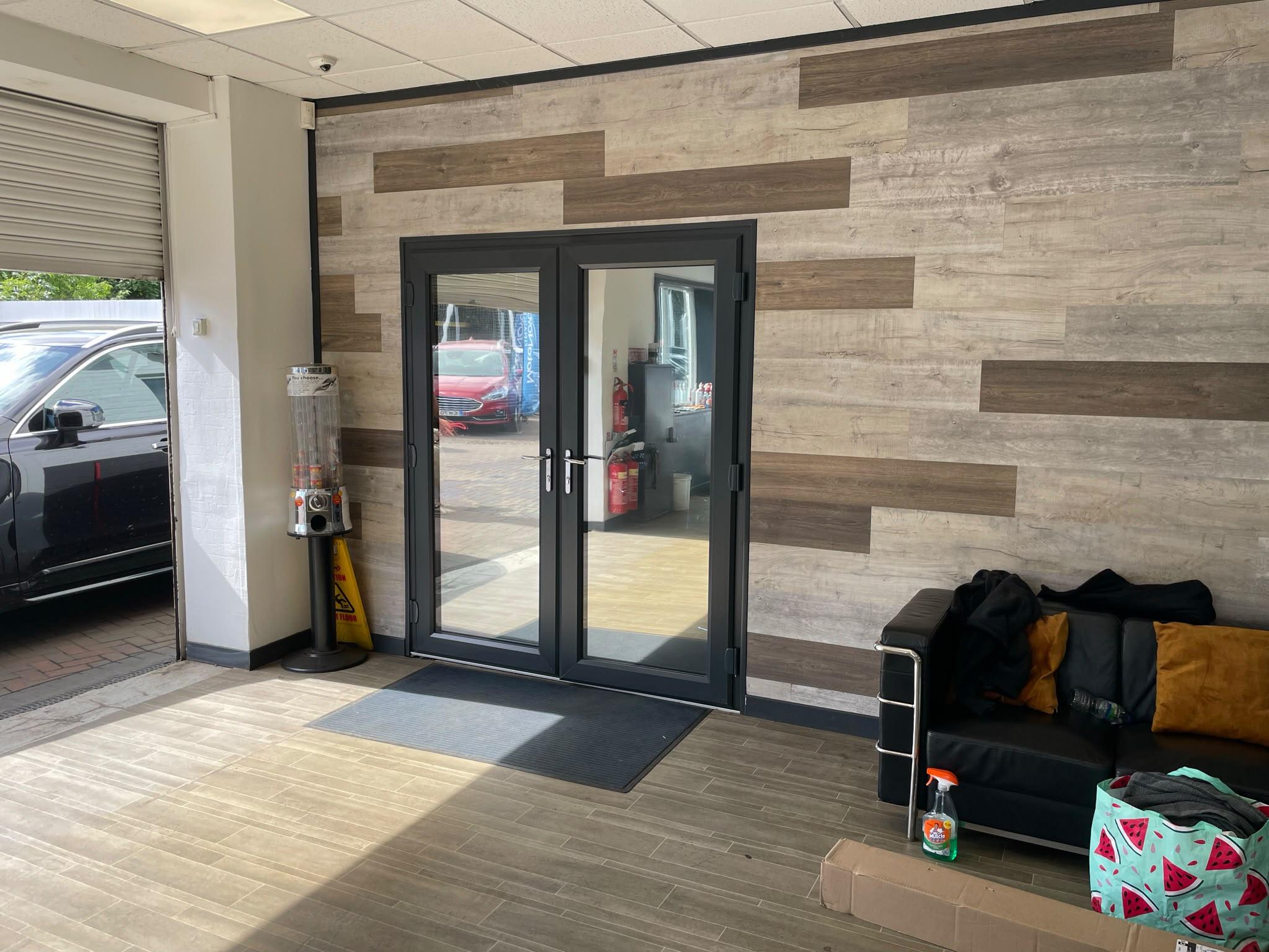 Glass double doors in a car showroom reception with clear glass
