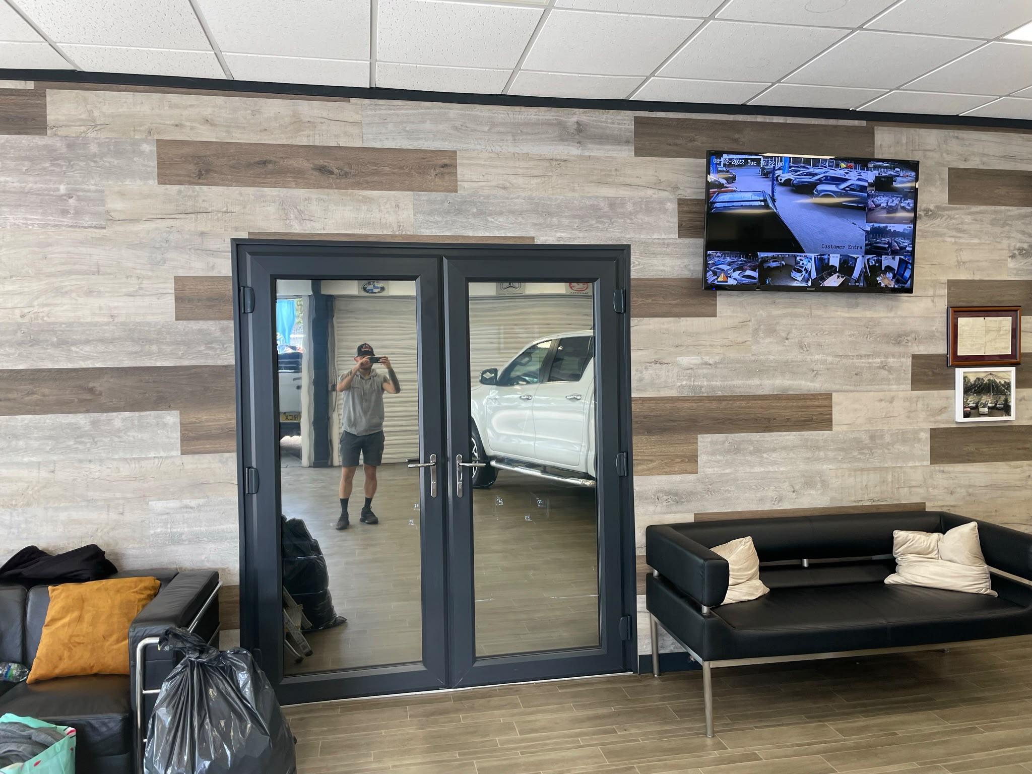 The same showroom doors after reflective film: the glass now shows the showroom, not the room behind