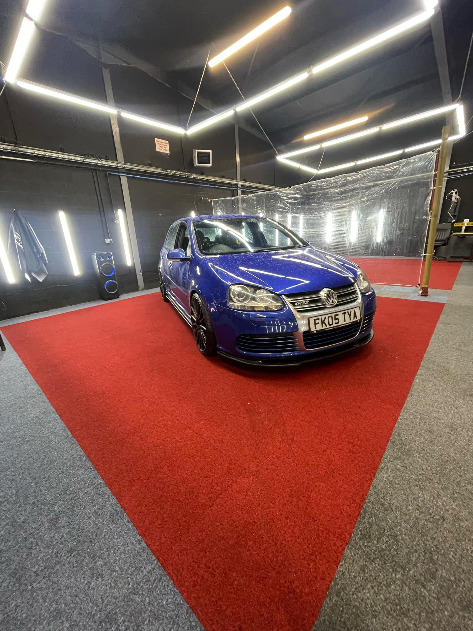 Blue VW Golf R on the red carpet in the Tinting Brothers workshop